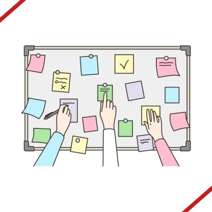 An image of multiple hands reaching for a board with sticky notes.