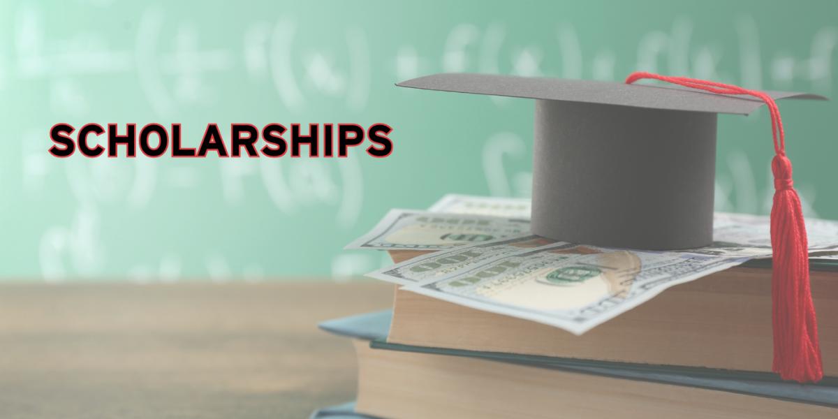 A graduation cap on top of money and a book in front of a chalkboard.