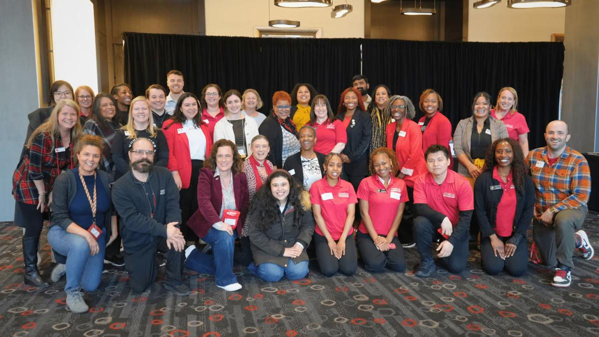 Three rows of Career Center staff posing for a group photo in a large room.