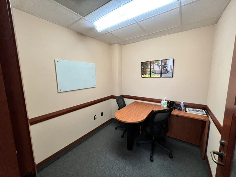 Wooden office table with two chairs in an interview room