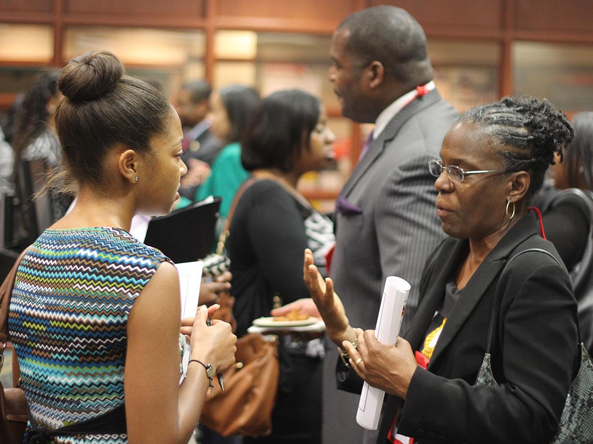 An employer speaking with a student during an event