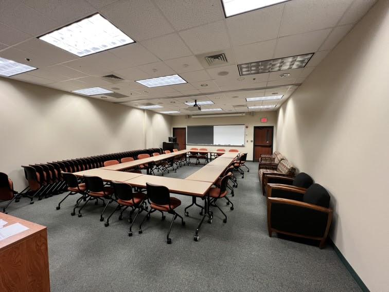 Large rectangular conference table surrounded by office chairs