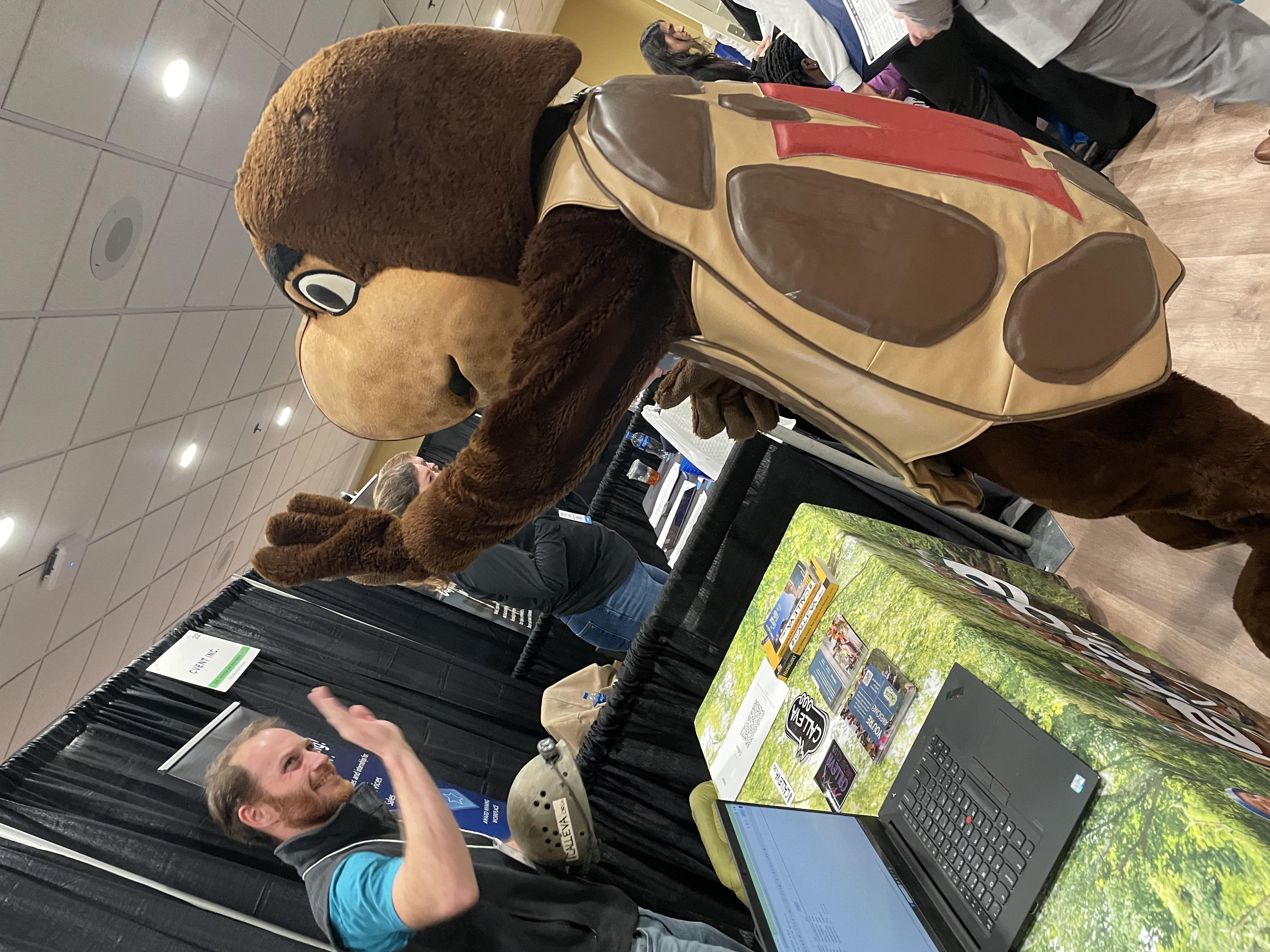 Testudo giving an employer a high five